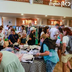 Evacuees sort through clothes in hotel