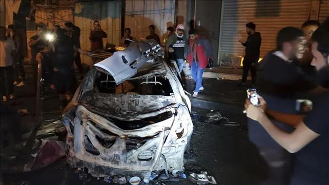 מפגינים ליד רכב תופת שהתפוצץ בבגדאד 16.11.19