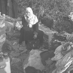 Palestinian woman amid building rubble in Gaza
